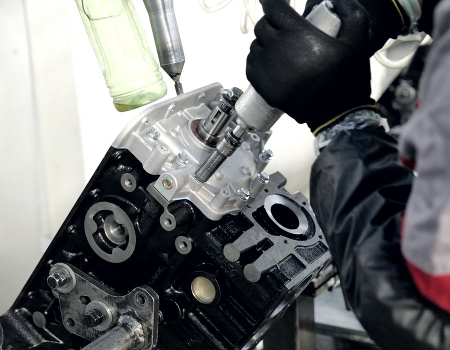 Hands assembling an engine