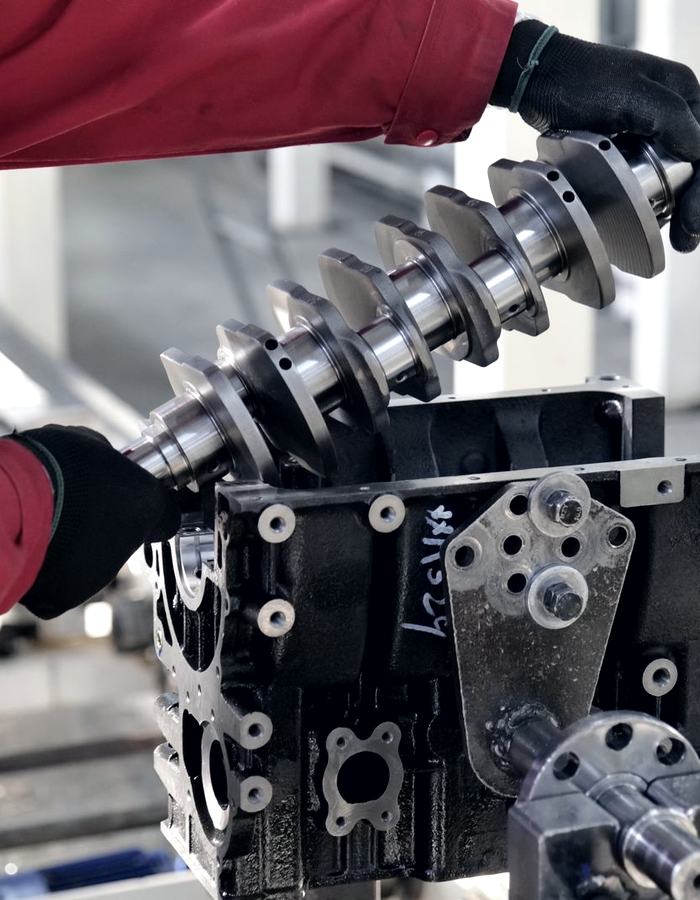 Crankshaft being fitted into an engine block during a rebuild